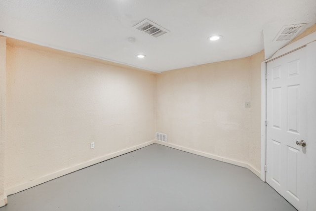 unfurnished room featuring concrete floors, recessed lighting, and baseboards
