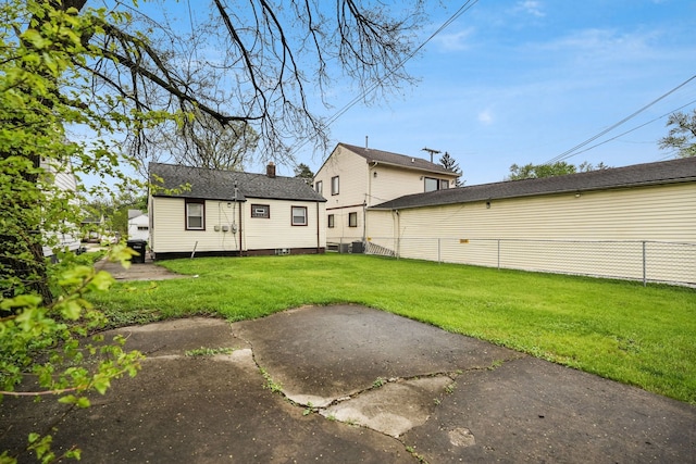 rear view of property featuring a chimney