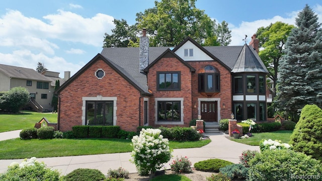 1947 Maplewood Ave, Bloomfield Hills, MI 48302 - tudor home with brick siding, a chimney, and a front lawn