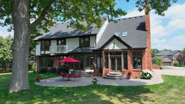 1947 Maplewood Ave, Bloomfield Hills, MI 48302 - back of house featuring a balcony, brick siding, a yard, and french doors