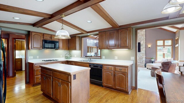 1947 Maplewood Ave, Bloomfield Hills, MI 48302 - kitchen featuring black appliances, a kitchen island, light countertops, light wood finished floors, and pendant lighting