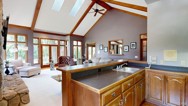 1947 Maplewood Ave, Bloomfield Hills, MI 48302 - kitchen with high vaulted ceiling, open floor plan, dark countertops, a peninsula, and beam ceiling