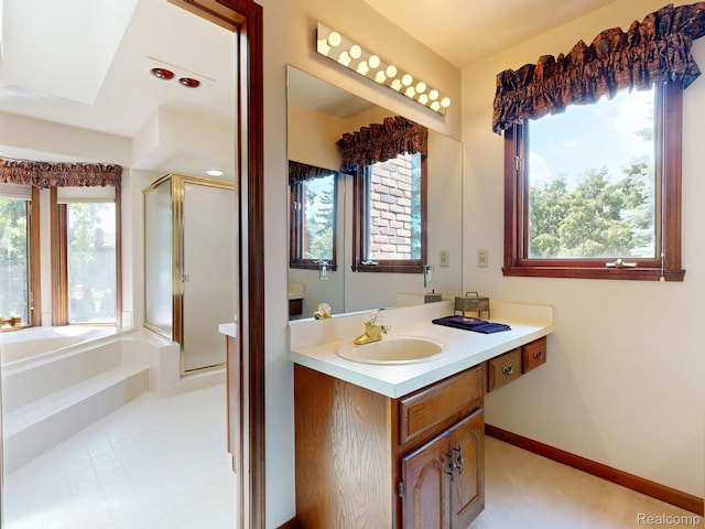 1947 Maplewood Ave, Bloomfield Hills, MI 48302 - bathroom with a shower stall, vanity, a garden tub, and a skylight