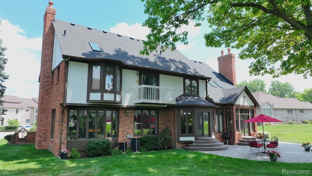 1947 Maplewood Ave, Bloomfield Hills, MI 48302 - back of house with a chimney, brick siding, a lawn, a patio area, and a shingled roof