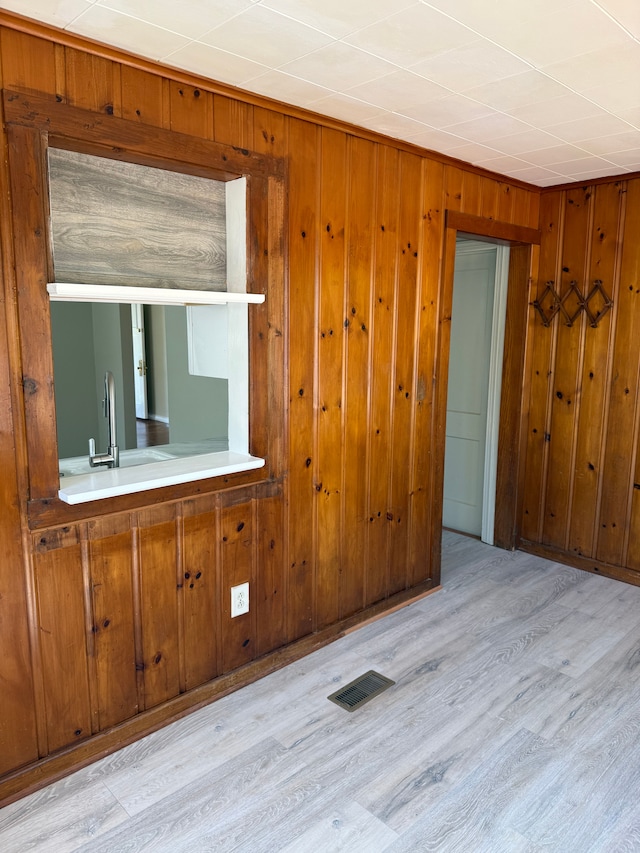 609 Buckingham Ave, Flint, MI 48507 - empty room featuring light wood-type flooring and wood walls