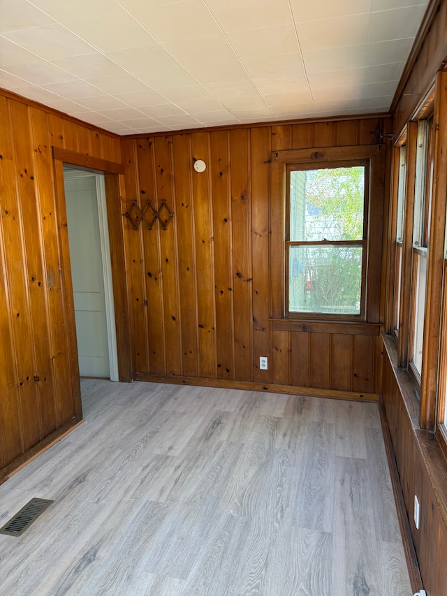 609 Buckingham Ave, Flint, MI 48507 - unfurnished room featuring light wood-style flooring and wooden walls