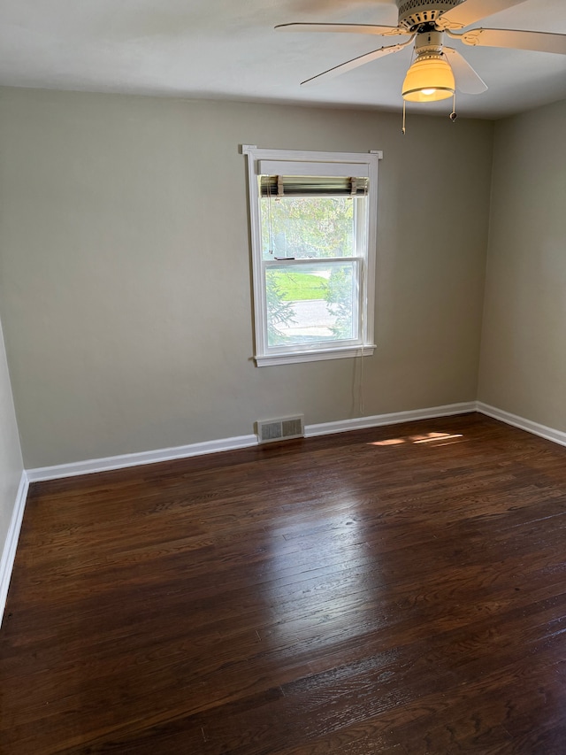 609 Buckingham Ave, Flint, MI 48507 - spare room with dark wood-style flooring, baseboards, and ceiling fan