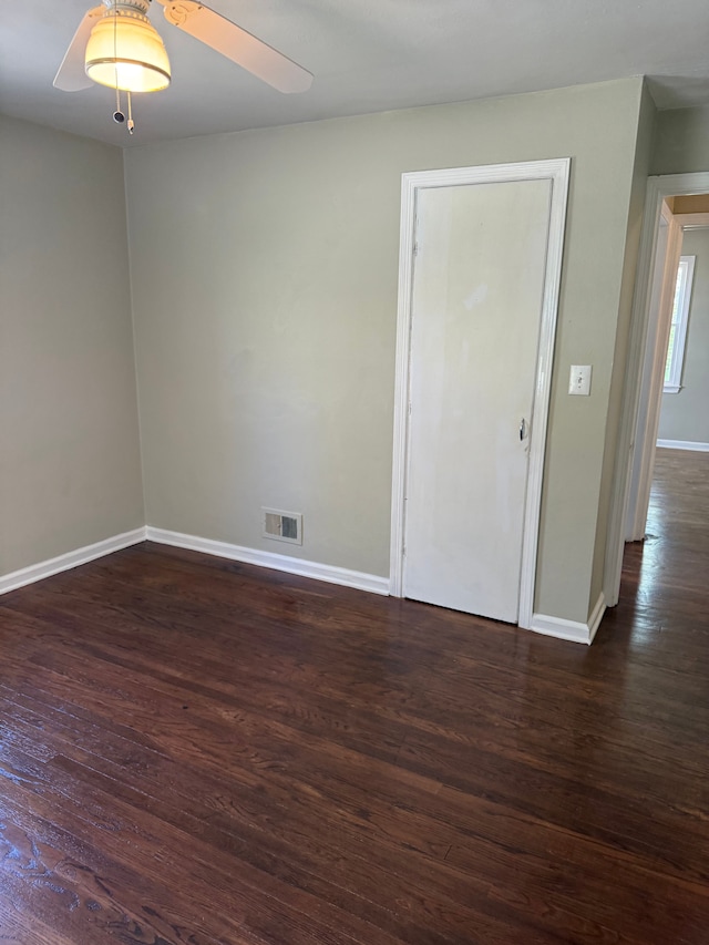 609 Buckingham Ave, Flint, MI 48507 - empty room with baseboards, dark wood-type flooring, and ceiling fan