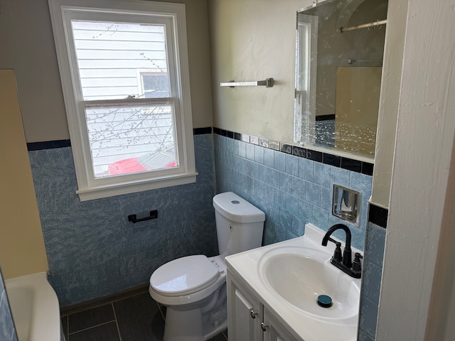 609 Buckingham Ave, Flint, MI 48507 - full bathroom with tile walls, toilet, tile patterned floors, a shower, and a wainscoted wall