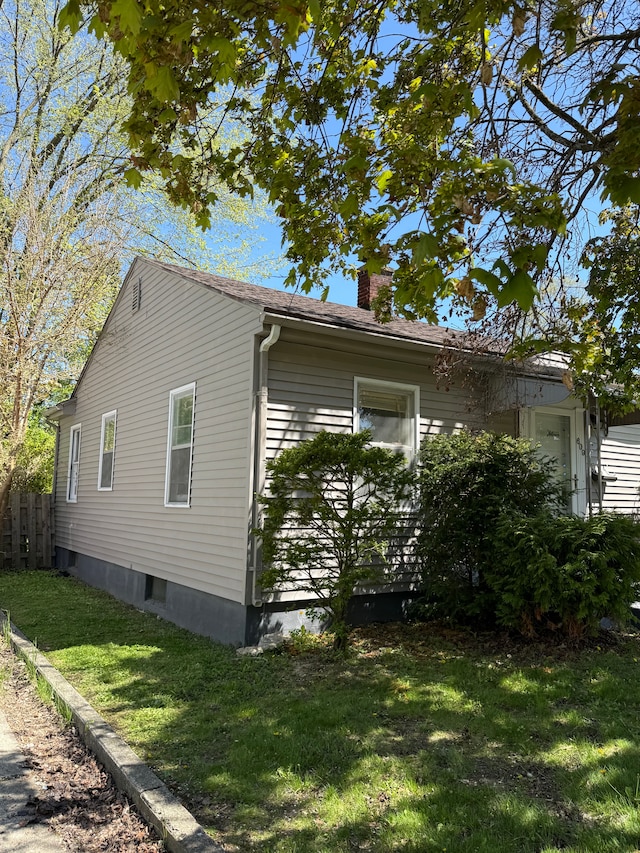 609 Buckingham Ave, Flint, MI 48507 - view of side of property with a chimney