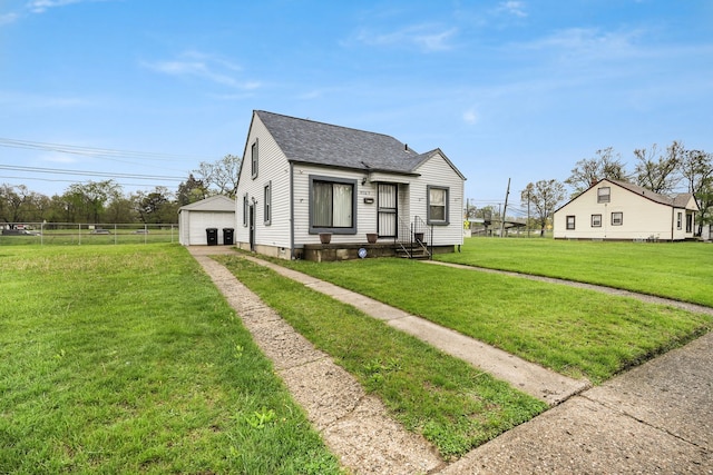 bungalow with a shingled roof and a detached garage