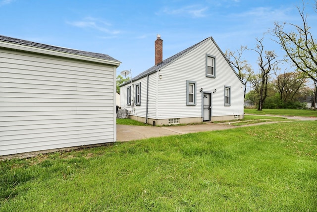 back of house with a lawn