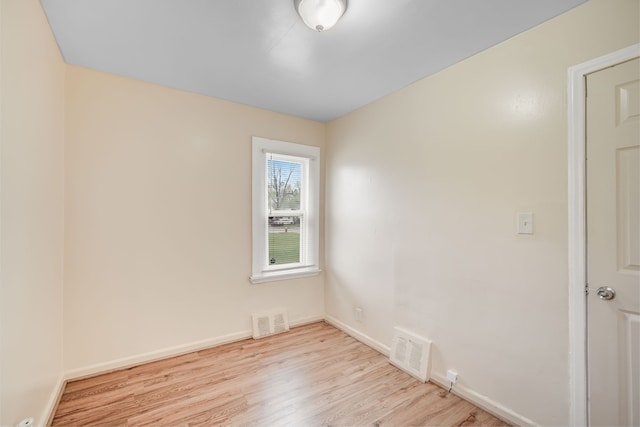 unfurnished room featuring wood finished floors and baseboards