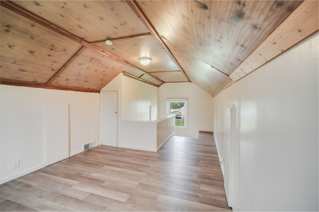 additional living space featuring wood ceiling, light wood finished floors, vaulted ceiling, and baseboards