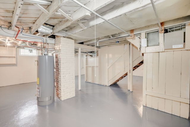 basement with water heater and stairway