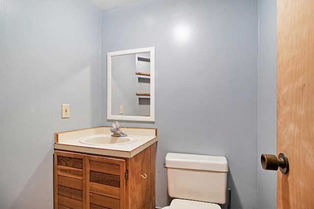 half bathroom with toilet and vanity