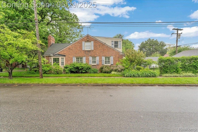 4800 Bishop St, Detroit, MI 48224 - traditional-style house with brick siding, a chimney, and a front yard