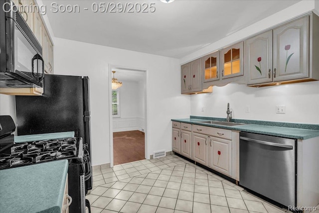 4800 Bishop St, Detroit, MI 48224 - kitchen featuring black appliances, a sink, light tile patterned floors, dark countertops, and gray cabinets