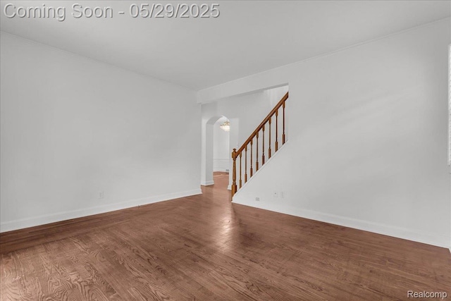 4800 Bishop St, Detroit, MI 48224 - unfurnished room with arched walkways, wood finished floors, baseboards, and stairway