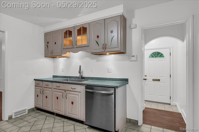 4800 Bishop St, Detroit, MI 48224 - kitchen featuring stainless steel dishwasher, a sink, dark countertops, light tile patterned flooring, and glass insert cabinets