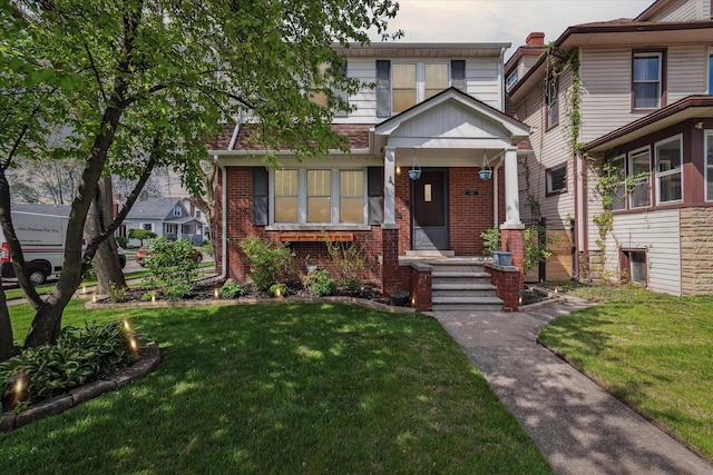 view of front of house featuring a front yard and brick siding