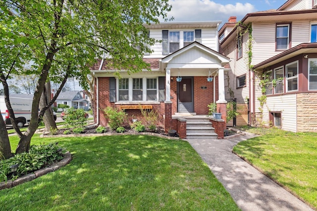 view of front facade featuring a front lawn and brick siding