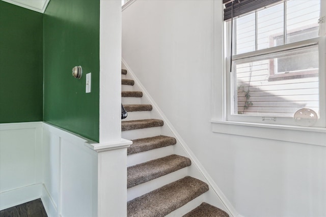 staircase featuring wainscoting