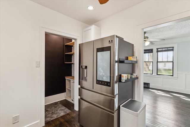 kitchen with a ceiling fan, dark wood finished floors, white cabinetry, stainless steel fridge with ice dispenser, and a wainscoted wall