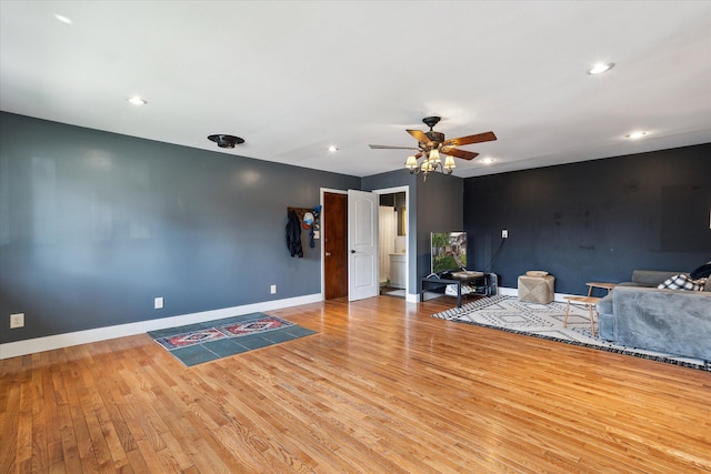 living room featuring recessed lighting, baseboards, a ceiling fan, and wood finished floors