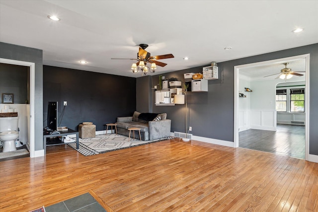 living area featuring recessed lighting, visible vents, a ceiling fan, and hardwood / wood-style flooring