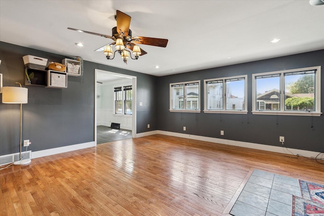 interior space with baseboards, light wood-style flooring, a ceiling fan, and recessed lighting