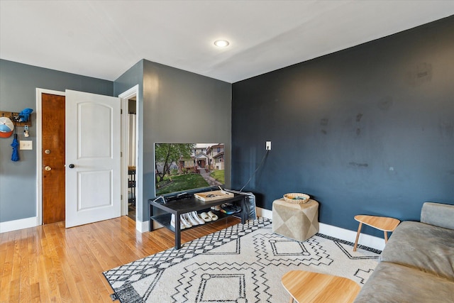 living room with baseboards and light wood-type flooring