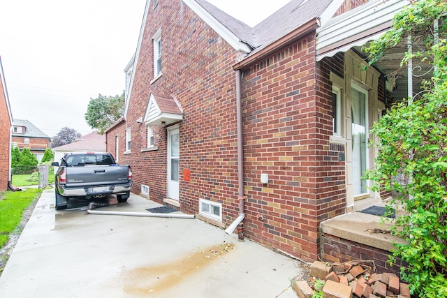 view of home's exterior with driveway and brick siding