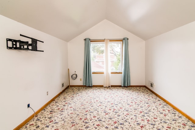 additional living space featuring light colored carpet, visible vents, baseboards, and lofted ceiling