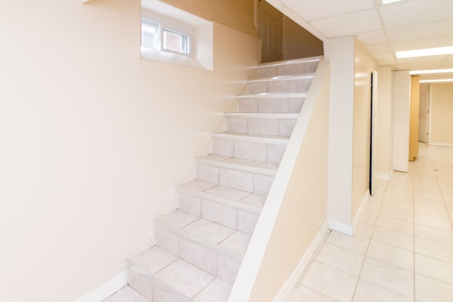 staircase with tile patterned flooring and baseboards