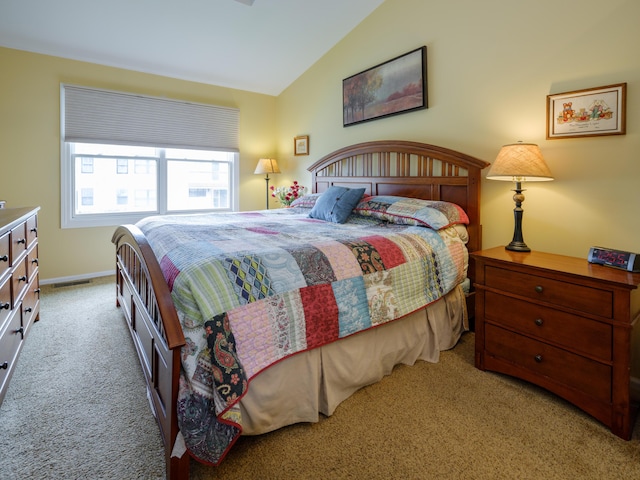 carpeted bedroom featuring vaulted ceiling, baseboards, and visible vents