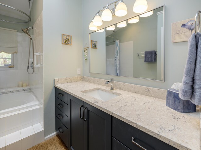 full bathroom featuring tiled shower / bath and vanity