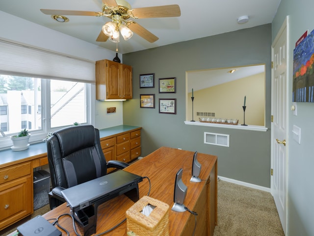 home office with ceiling fan, light colored carpet, baseboards, and visible vents
