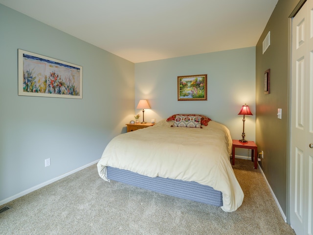 bedroom featuring visible vents, baseboards, and carpet floors