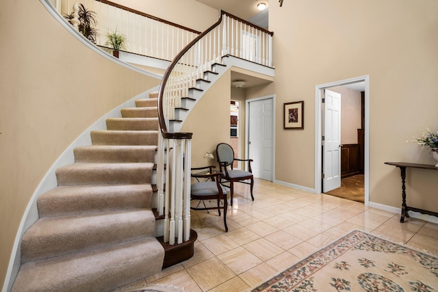 3603 Creekside Dr, Ann Arbor, MI 48105 - stairs featuring baseboards and a towering ceiling