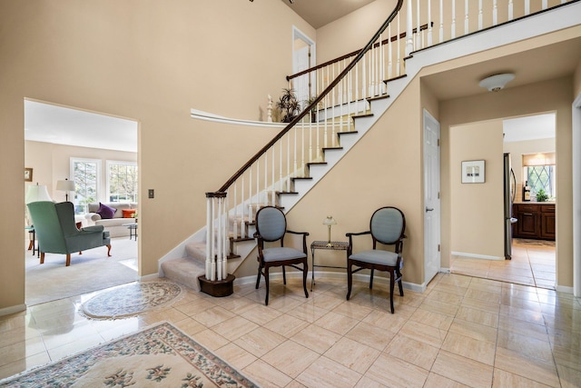 3603 Creekside Dr, Ann Arbor, MI 48105 - staircase featuring baseboards and a high ceiling
