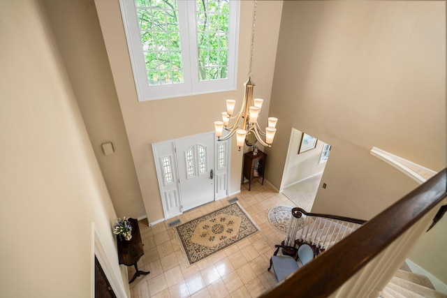 3603 Creekside Dr, Ann Arbor, MI 48105 - foyer entrance featuring a chandelier, a high ceiling, baseboards, and light tile patterned floors