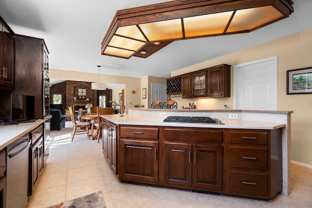 3603 Creekside Dr, Ann Arbor, MI 48105 - kitchen featuring light tile patterned floors, glass insert cabinets, dark brown cabinets, decorative light fixtures, and appliances with stainless steel finishes