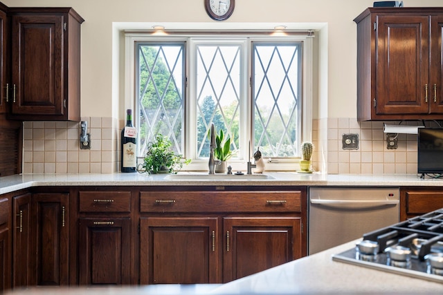 3603 Creekside Dr, Ann Arbor, MI 48105 - kitchen with backsplash, light countertops, a sink, and dark brown cabinetry