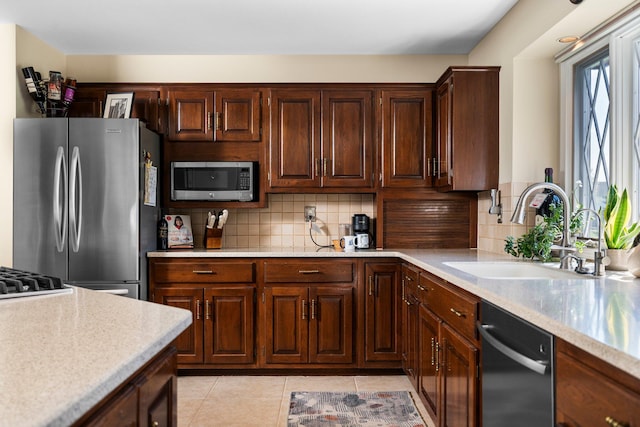 3603 Creekside Dr, Ann Arbor, MI 48105 - kitchen featuring a sink, stainless steel appliances, tasteful backsplash, and light countertops