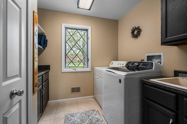 3603 Creekside Dr, Ann Arbor, MI 48105 - washroom with baseboards, light tile patterned floors, washer and dryer, visible vents, and cabinet space