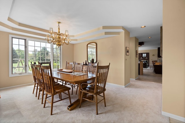3603 Creekside Dr, Ann Arbor, MI 48105 - dining space featuring light colored carpet, baseboards, a raised ceiling, and a notable chandelier