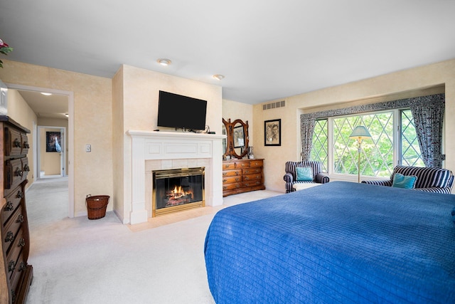 3603 Creekside Dr, Ann Arbor, MI 48105 - bedroom featuring carpet flooring, a tiled fireplace, and visible vents