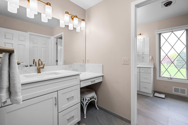 3603 Creekside Dr, Ann Arbor, MI 48105 - bathroom featuring visible vents, baseboards, and vanity