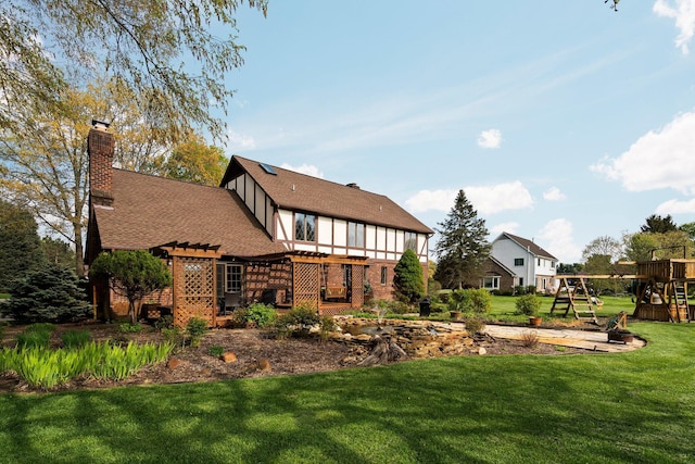 3603 Creekside Dr, Ann Arbor, MI 48105 - rear view of house with a shingled roof, a pergola, a chimney, a lawn, and a playground